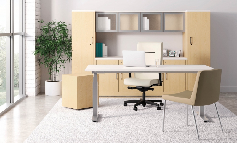 beige room with a beige desk and beige hutch with two closets that has one beige high back wheeling office chair behind the desk and one stationary beige chair in front of the desk
